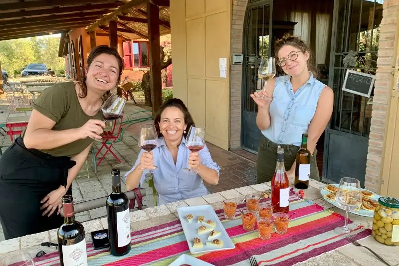 Chicca and guests tasting red and white wine acompanied by food served at Chiappini Winery (Bio) Chicca and guests tasting red and white wine acompanied by food served at Chiappini Winery (Bio)