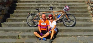 Chicca and Arnaud on stairs resting after riding a tandem bicylce