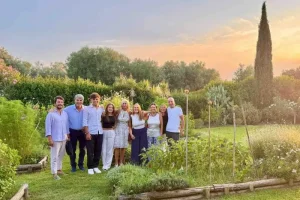 Chicca and guests in front of La Casa Toscana garden with home grown vegetables spices and fruits