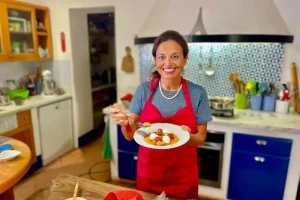 Chicca in kitchen with a fresh cooked Tuscan specialty