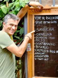 Guest reading the wine menu at restaurant with Sassicaia and Ornellaia wine