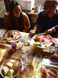 Guest sharing a local meal with wine