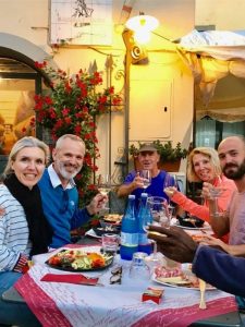 Guests sharing dinner and wine experience at local restaurant